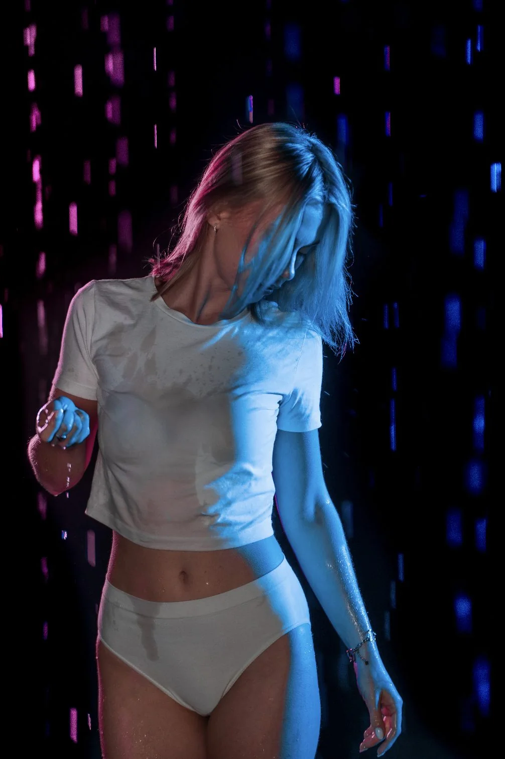 Rain Room — portret w neonowym deszczu, niebieskie i różowe światło